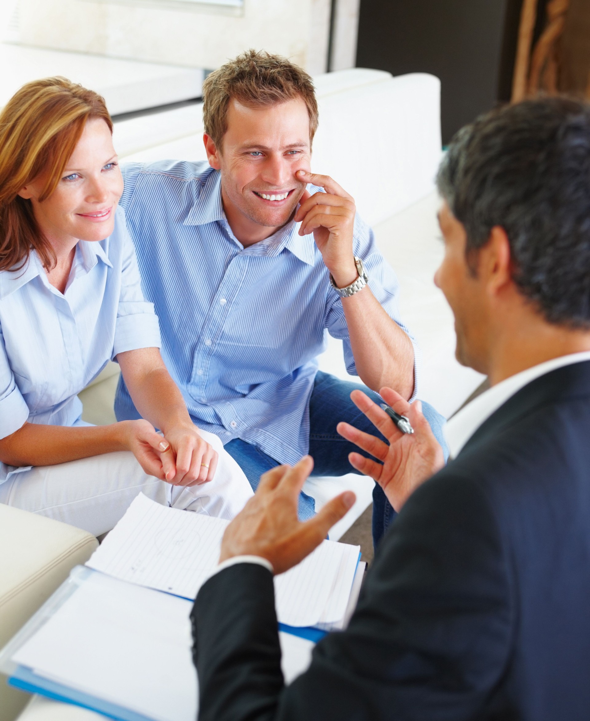 Happy couple discussing financial matter with consultant